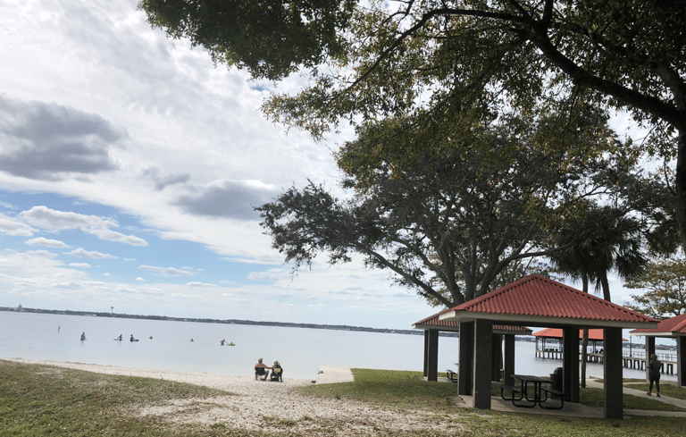 Sandy beach on Lake Jackson with Trees and canopies with picnic tables