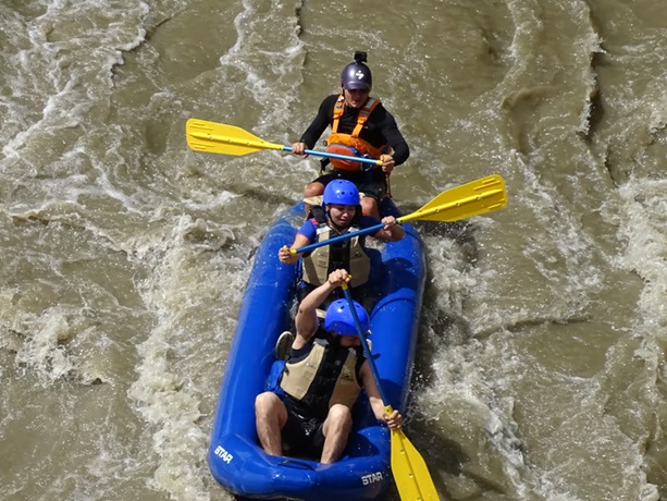 a group of people in duckie, navigating the fonce river in san gil, colombia.