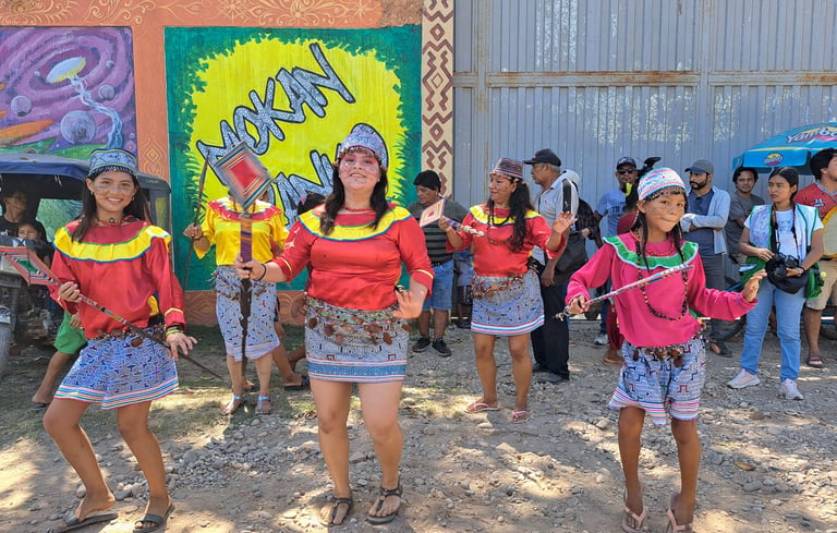 Indigenous Shipibo-Konibo women perform a traditional dance in colorful ethnic clothing during a cultural festival.