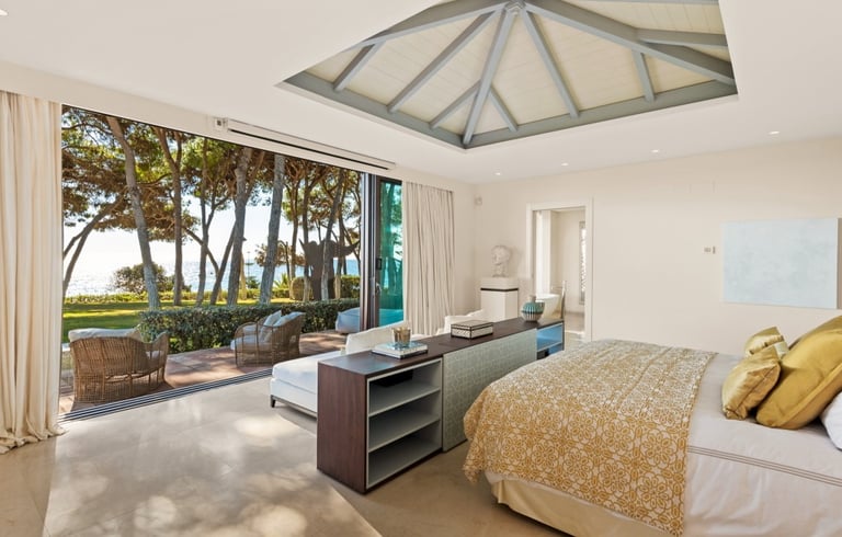 Master suite at Villa El Rincon in Marbella, offering unobstructed views of the gardens and the sea.