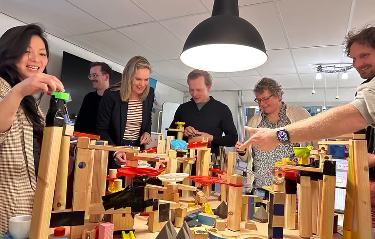 Colleagues collaborating on a systems thinking installation during a workshop.