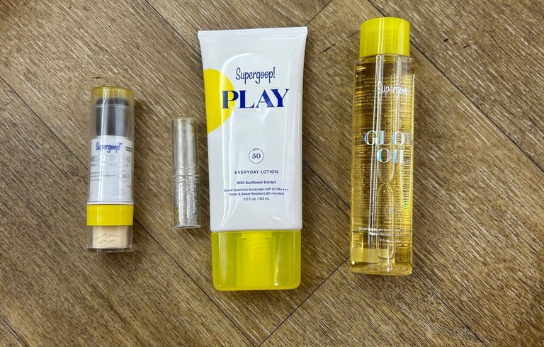 Flat lay of Supergoop! PLAY Lotion, Glow Oil, and SPF powders