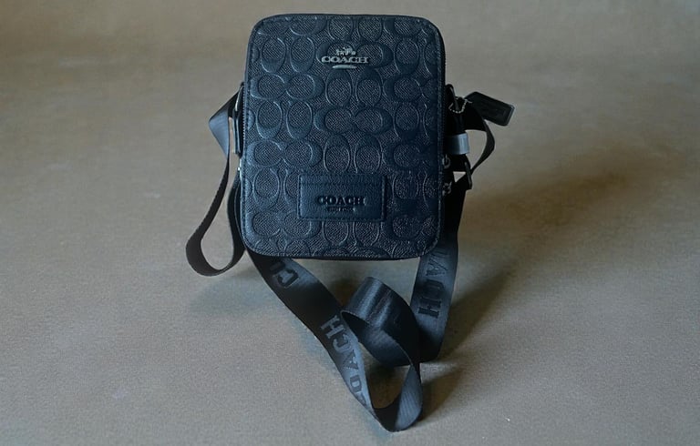 a small black purse with a black and white polka dot pattern