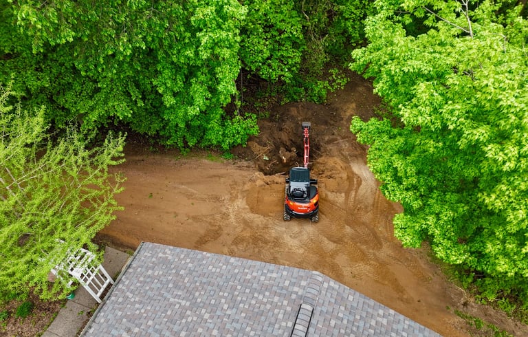 Kubota excavator digging dirt at residential home in central mn
