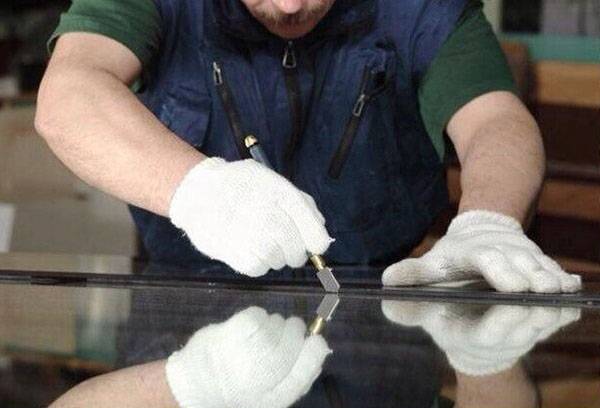 a man in a blue shirt and white gloves