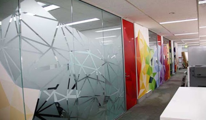 a wall of glass with a colorful wallpaper