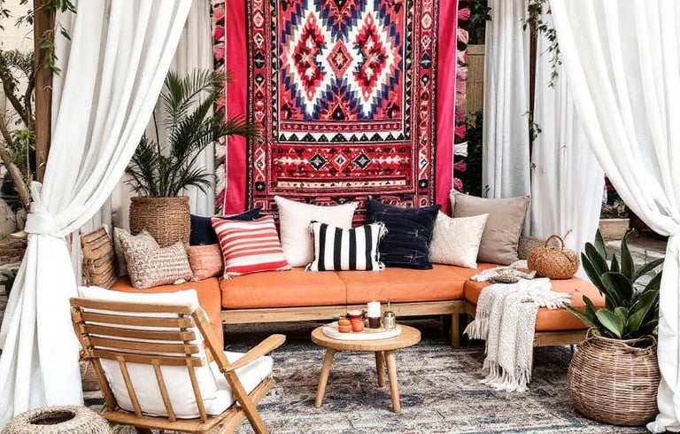 a boho garden patio with a couch and a rug 