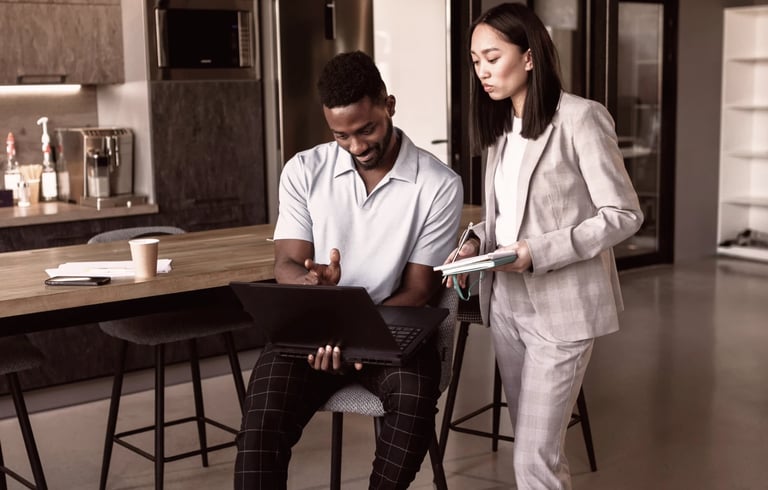 a man and woman standing in a office