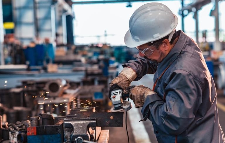 a man in a hard hat and a helmet on a machine
