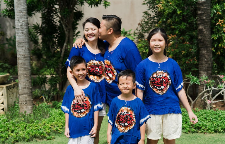 Natural sibling moment during extended family photography session at Lumbini Villas Jimbaran Bali with joyful expressions