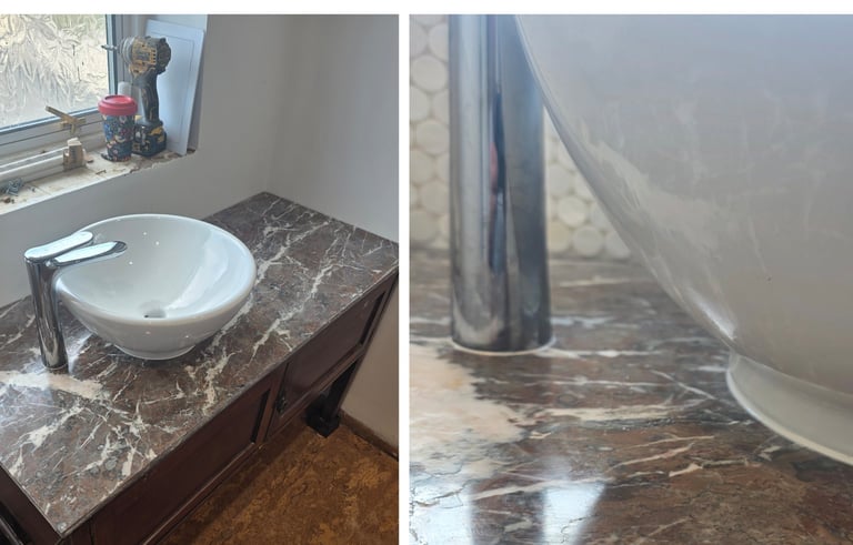A white vessel sink with a chrome faucet on a brown marble vanity countertop during a bathroom renovation.
