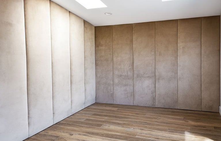 Elegant suede wall panels in neutral tones with wood flooring, custom-designed for a private theater room by Solo Home Decor.