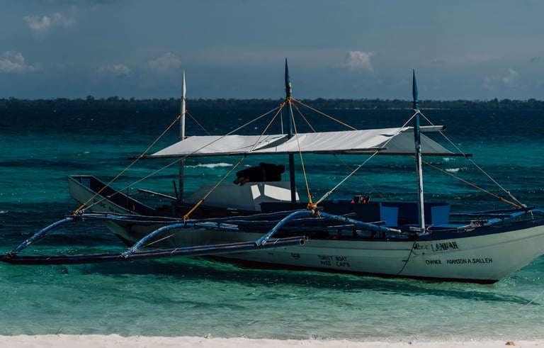 a boat on the beach with a boat in the water