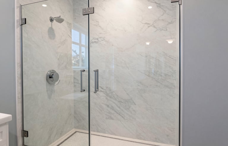 A luxurious bathroom remodel in a North American home, featuring a marble-tiled walk-in shower with a sleek glass door. The color palette includes off-white and pale blue accents, conveying a sense of high-end craftsmanship and modern elegance.