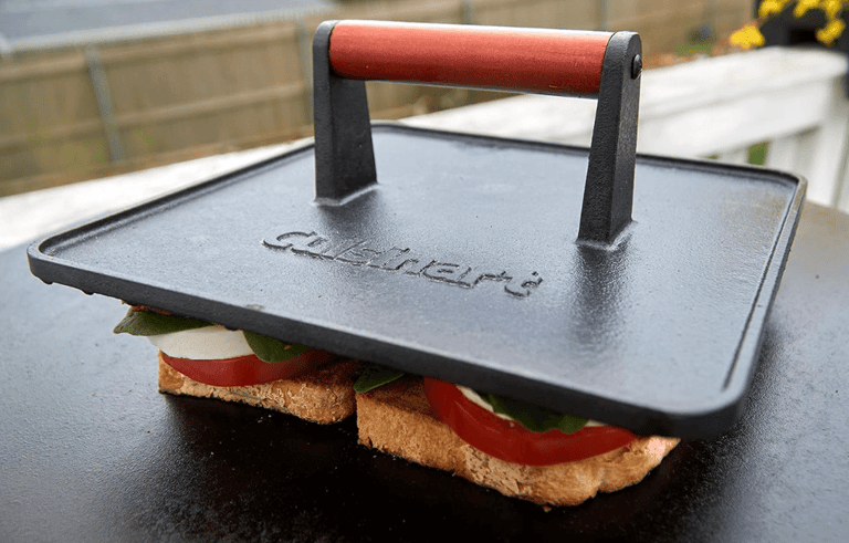 a sandwich with a grill press on top