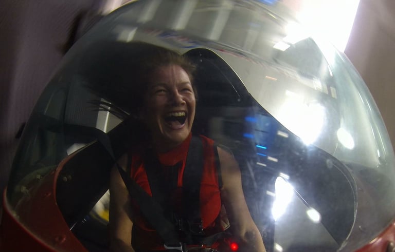 a woman in an open simulator cockpit