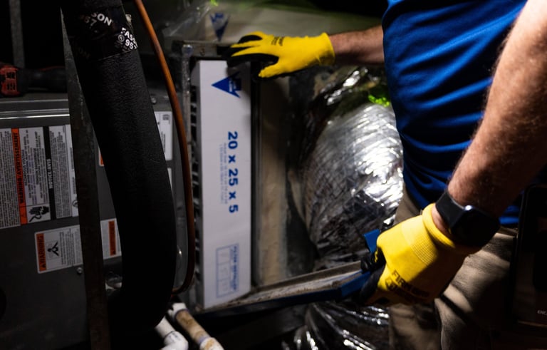 our tech performing routine maintenance on a home air conditioning & heating system  in Arlington TX