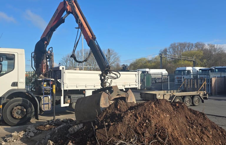 Commercial muck-away grab lorry on site in West Bromwich and Smethwick