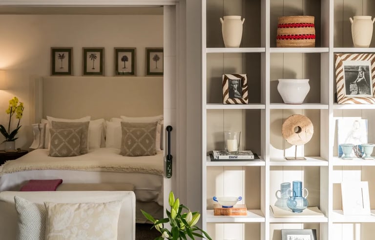 guest suite with soft neutral tones and decorative shelving at Villa El Olivo, Marbella
