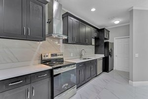 “Modern kitchen with high-end finishes, stainless steel appliances, and ample counter space, perfect