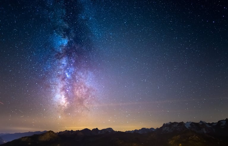 Milky Way galaxy over snowy mountains