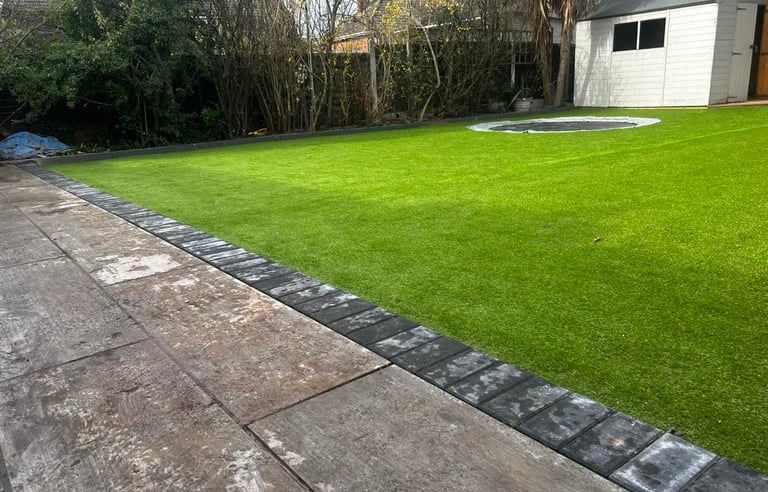 Modern garden design with patio, turf, and fencing in Worcester