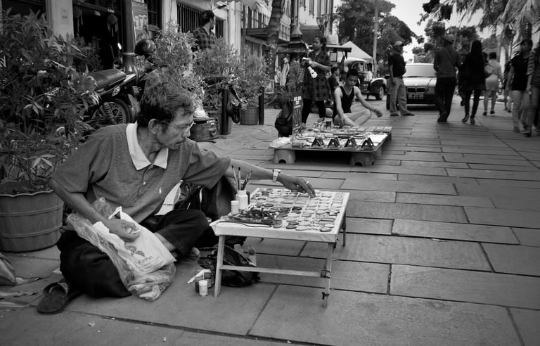 Peter Pickering photographs a street trader setting out his goods in Kota Tua, Jakarta