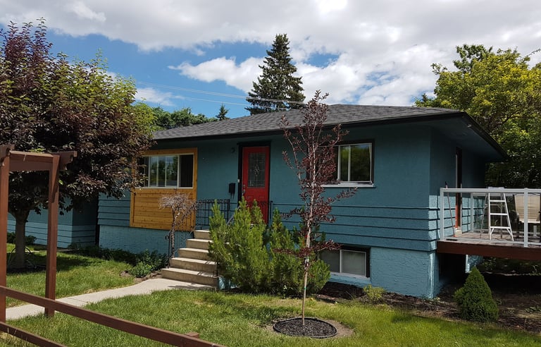 Exterior House Painting bungalow with two tone grey color with a accent red door
