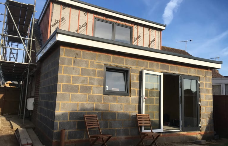 House extension under construction with blockwork and sliding doors in Brighton.