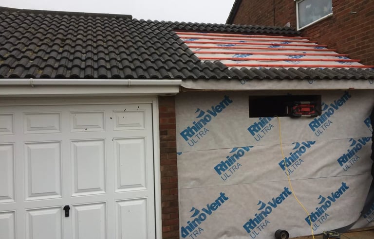 Garage conversion in progress with roof work and structural preparation in Brighton.