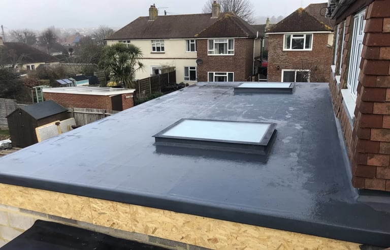 Rear loft dormer extension with rooflight on Sussex residential property.