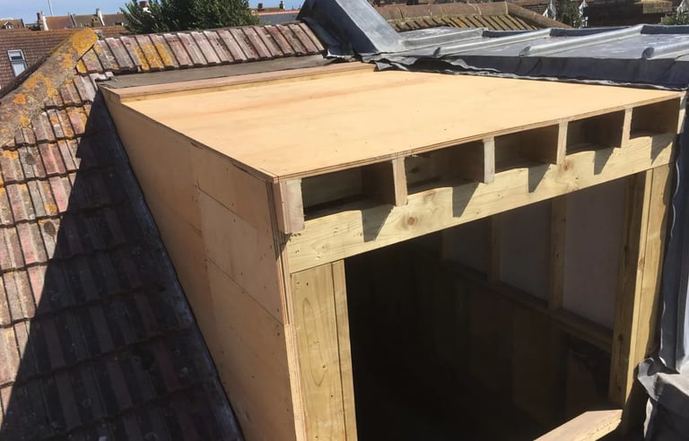 Timber dormer structure under construction during loft conversion in Brighton.