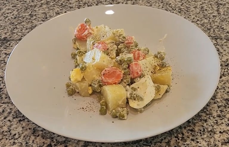a plate on a counter with Russian salad