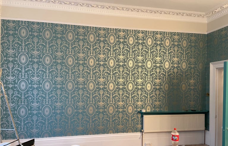 Elegant teal and gold damask wallpaper installed in a room n Sussex.