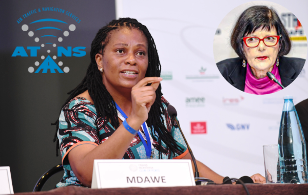 a woman in a colorful dress and glasses at a press conference