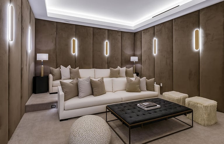 Luxurious home theater with custom wall panels, plush sofa, modern lighting, and stylish coffee table by Solo Home Decor.