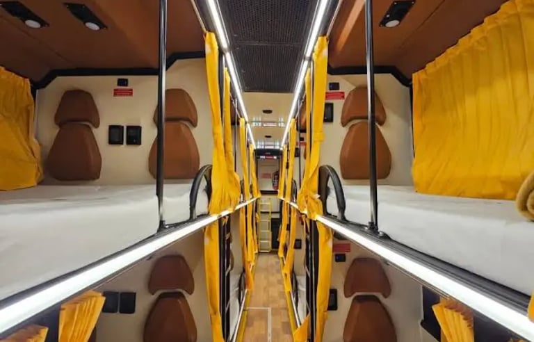 sleeper bus interior for overnight group travel in Delhi NCR