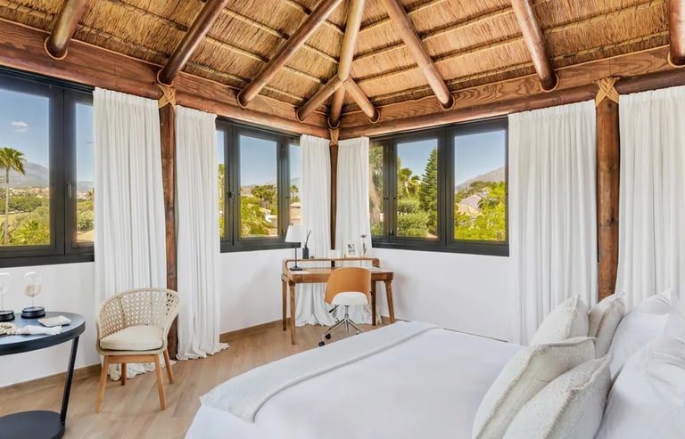 Penthouse suite with thatched ceiling and panoramic mountain views at Villa El Olivo, Marbella