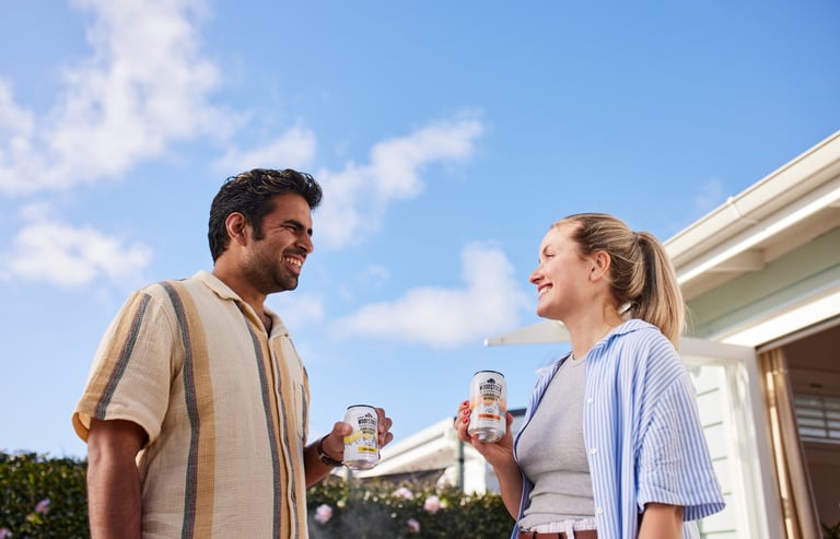Product photography - a man and woman standing outside of a house