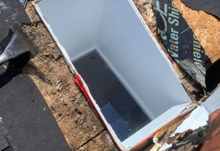 Professional skylight repair on a shingled roof with waterproof ice and water shield membrane.