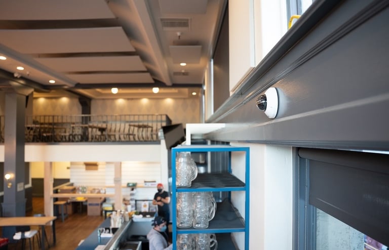 Cloud-Based Surveillance Camera Installed on Wall in Restaurant