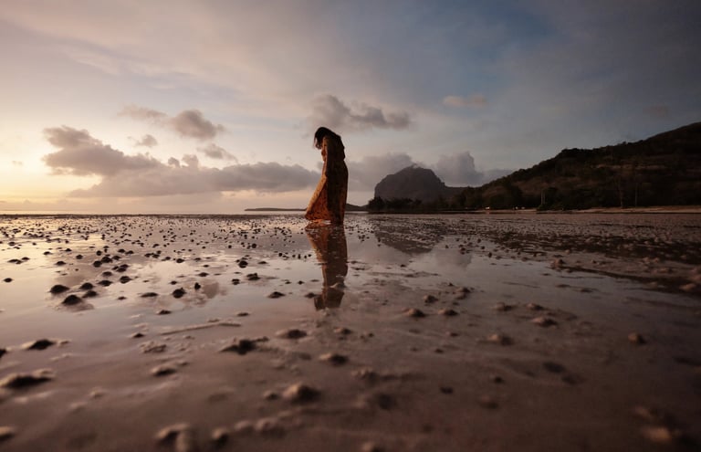 Silhouette of a woman on the beach with Le Morne Brabant in the background, Mauritius