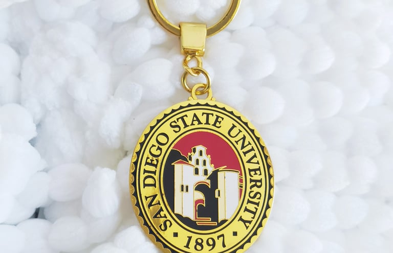 a gold keychain of San Diego State University