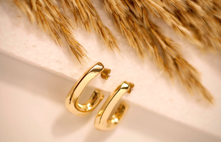 gold hoop earrings product photography UK, styled with wheat on white background - Basma Lens