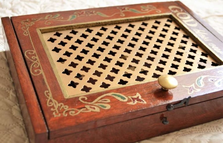 a wooden box with a golden handle