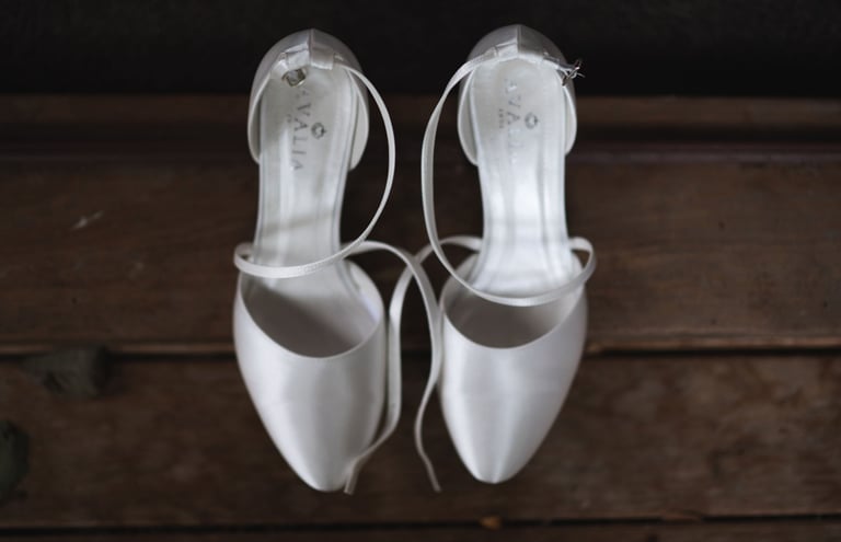 a bride's pair of white wedding shoes
