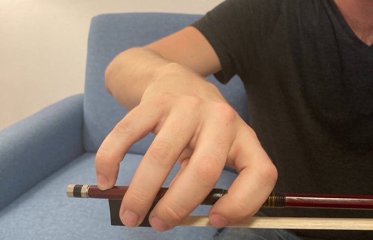 Violin bow held perfectly by a violin student 