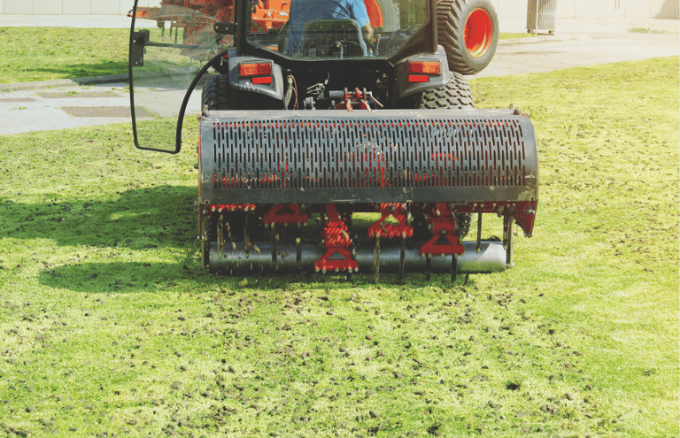 Professional lawn aeration service relieving compacted soil for healthier grass growth
