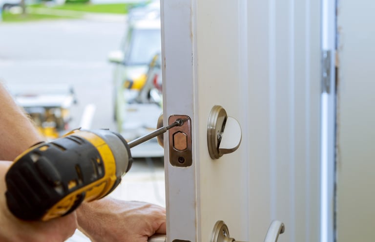 a man is using a drillet to fix a door handle