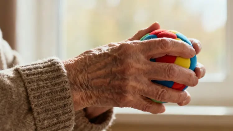 Therapeutic hand activity for dementia – gentle squeezing of a stress ball to reduce restlessness and promote grounding